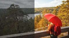 Nainen punaisen sateenvarjon kanssa kansallispuistossa syksyisellä näköalalla